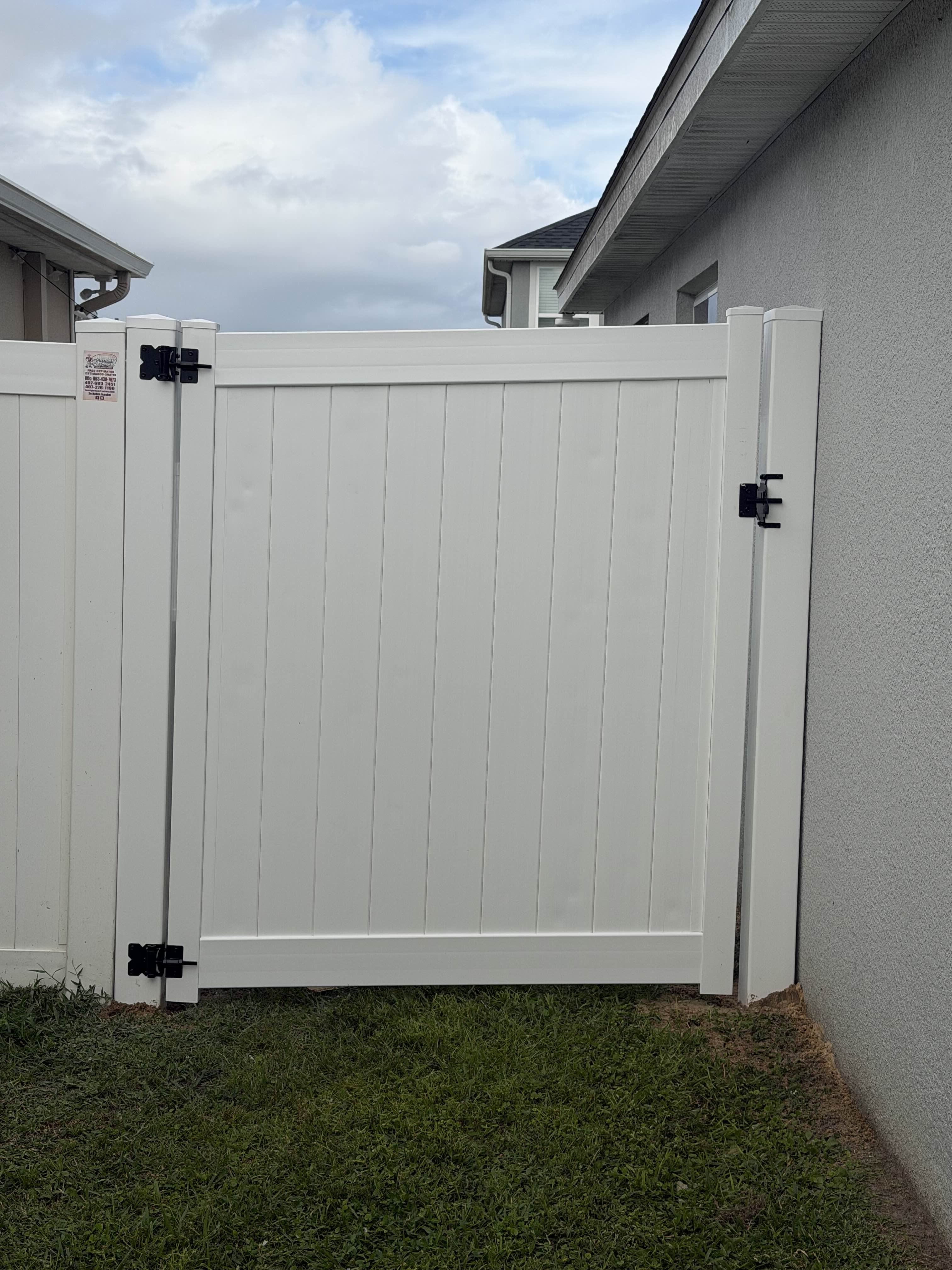White vinyl gate installation